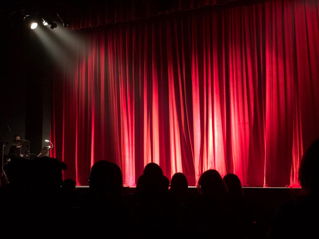 A stage and red curtain